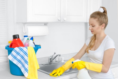 Technician cleaning a kitchen appliance in a Marylebone apartment